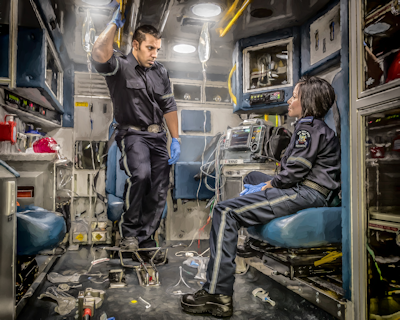 Image of two EMS providers in the back of an ambulance. Art by Dan Sundahl